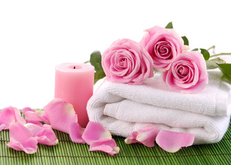 Fototapeta na wymiar pink rose petals and towel on green mat