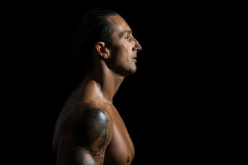 Muscular man in a black background