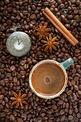 Coffee beans, cup of coffee, cinnamon and star anise