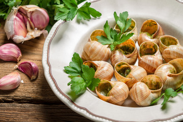 Closeup of snails baked in garlic butter and served with parsley
