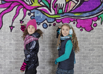 Girls with spray can and wall