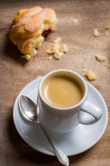 Black espresso and a fresh croissant