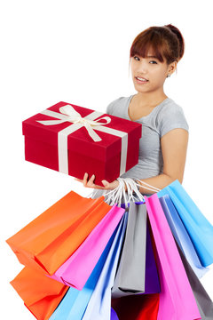 Isolated young Asian woman with shopping bags