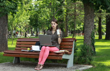 Young Woman Studying in a Park