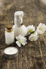 Fototapeta na wymiar Aromatic spa set with candle , cherry flower, salt in glass