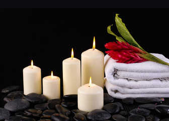 Fototapeta na wymiar spa composition of towel, candles and Ginger flower,
