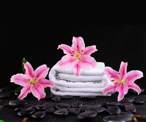 Fototapeta na wymiar Spa feeling with three lily ,towel ,pebbles