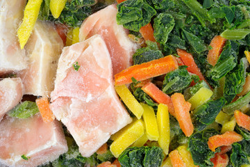 A close view of a frozen salmon and vegetables TV dinner