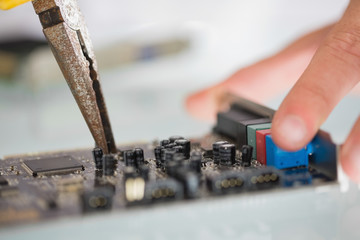 Extreme close up of pliers repairing hardware