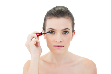 Fototapeta premium Focused natural brown haired model applying mascara