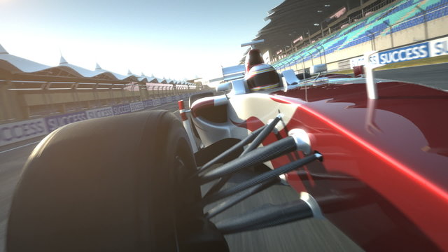 Formula One race car speeding along home stretch and past camera