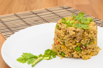 Fried rice yellow curry with pork on bamboo mat