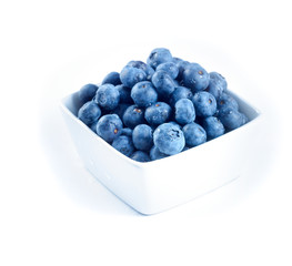 blueberries in a bowl isolated on a white background