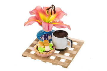 Coffee with cupcake and lilly flower
