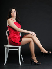 Fototapeta na wymiar showgirl woman dance in red dress chair