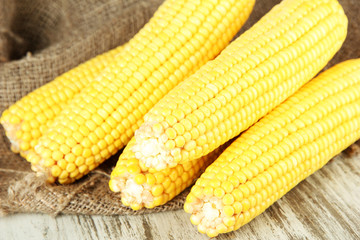 Crude corns on sackcloth on wooden table