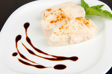 Boiled chicken meat with paprika and sauce,on white plate,