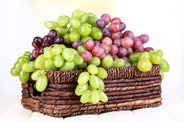Ripe green and purple grapes in basket