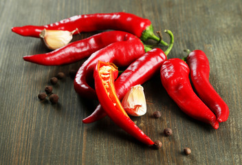 Red hot chili peppers  and garlic, on wooden background