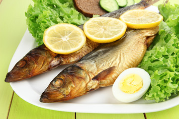 Smoked fish on plate close up