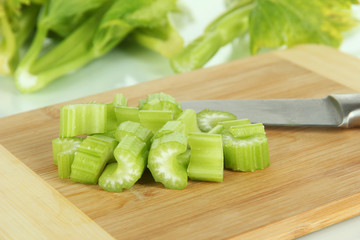 Fresh green celery on cutting board close-up