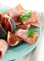 Tasty figs with ham, isolated on white