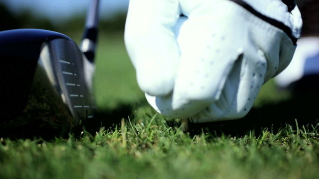 Professional Golfer Teeing Off