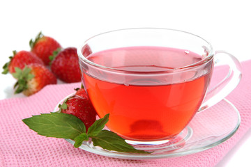 Delicious strawberry tea on table on white background