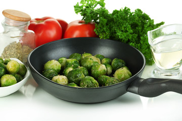 Fresh brussels sprouts in pan with vegetables and spices