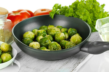 Fresh brussels sprouts in pan with vegetables and spices