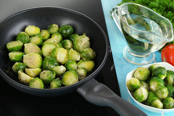 Fresh brussels sprouts in pan on cooking surface close-up