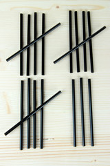 Cocktail tubes - counting days concept on wooden background