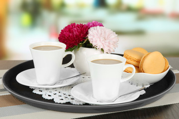 Cups of coffee on tray on table in cafe