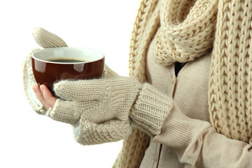 Female hands with hot drink, on light background