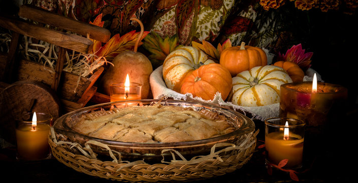 Pumpkins and cake on candle light still life