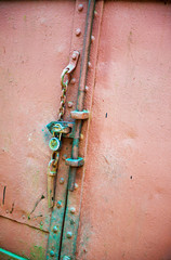 Weathered old door with lock and chain