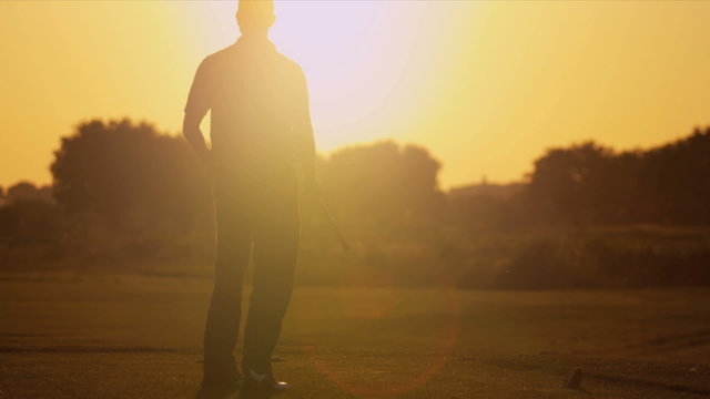 Male Golfer Sunset Silhouette Following Shot 