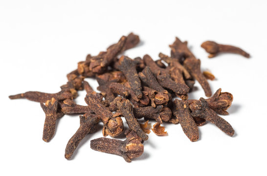 Dry cloves on white background. Selective focus.