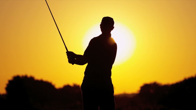 Male Golfer Sunset Silhouette Following Shot 