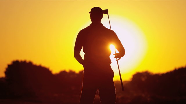 Male Golfer Sunset Silhouette Following Shot 