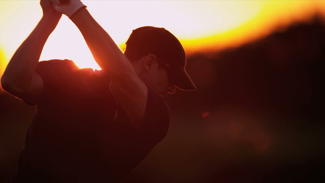 Golfer Driving Off Sunset Golf Resort Fairway