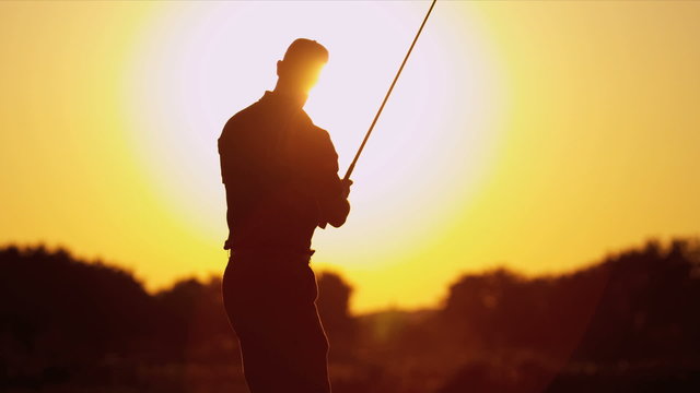 Golfer Driving Off Sunset Golf Resort Fairway