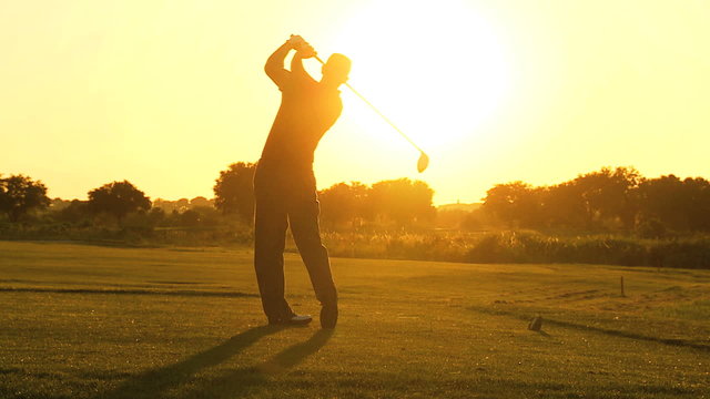 Professional Golfer Sunset Teeing Off 