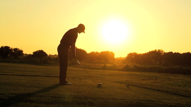 Male Caucasian Golfer Practicing Swing Sunset 