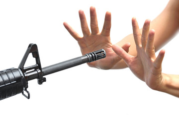 a rifle pointing to empty hands