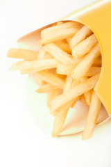 french fries in a paper wrapper on white background