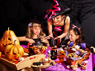 Family on Halloween party with children.