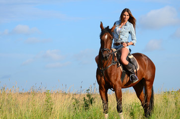 The woman on a horse in the field