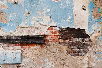 Old crumbling plastered brick wall
