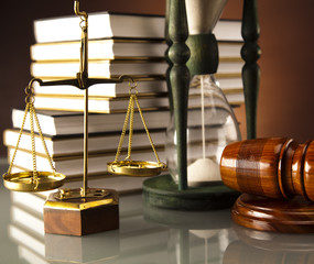 Wooden gavel and book, Statue of Lady Justice, hourglass